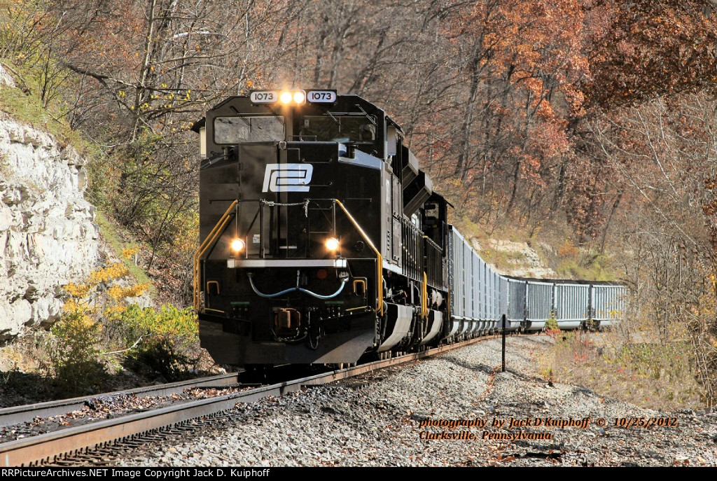 Norfolk Southern, Penn Central Heritage unit 1073 NS 1017, leads a northbound coal train N07 on the ex Monongahela Railway, at Clarksville, Pennsylvania. October 25, 2012. 